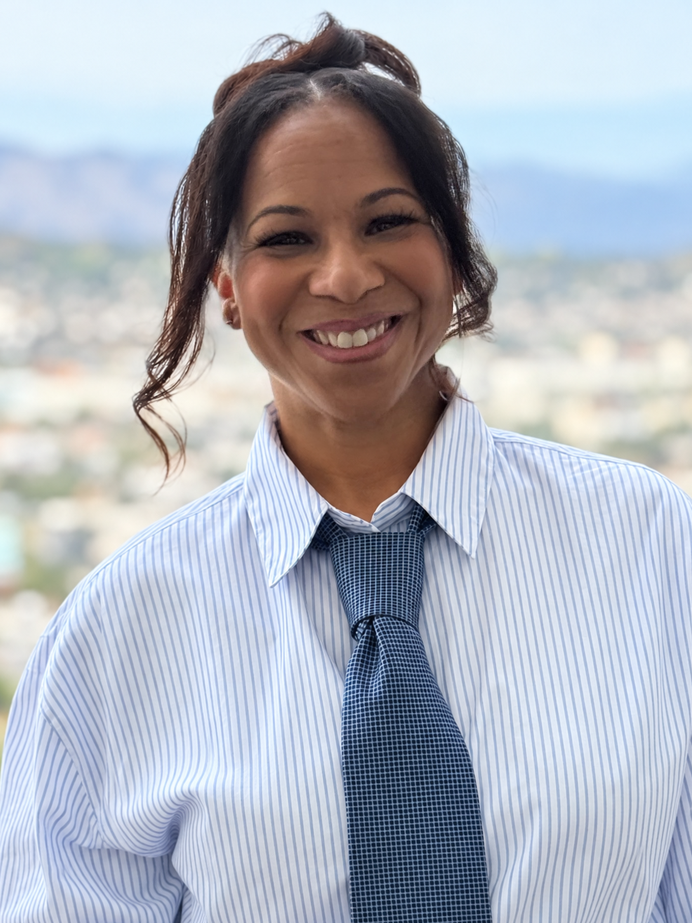 Jill Munroe portrait in a striped shirt and tie